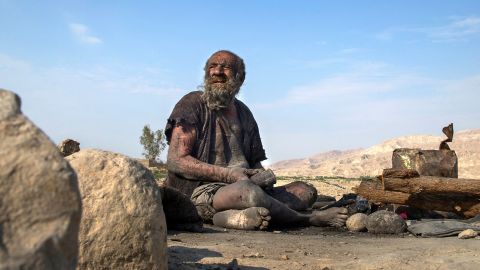 Amu Haji sits on the ground on the outskirts of the village of Dezhgah in the southwestern Iranian Fars province, on December 28, 2018. 
